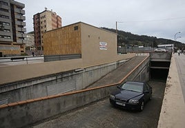 Un coche saliendo del aparcamiento de Ferreros, en Ciudad Naranco.