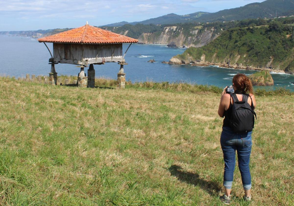 Una mujer fotografía las vistas desde el mirador de La Regalina.