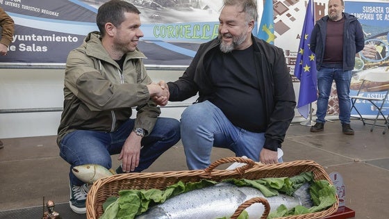 Javier Bueno, el pescador sacó el Campanu, estrecha la mano a Pedro Caramés, que ganó la subasta y se llevará el ejemplar al restaurante La Finca de Oviedo.