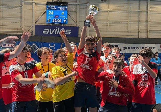 Los jugadores avilesinos levantan la copa de campeones.