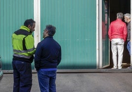 Compañeros del trabajo de  la víctima se dan apoyo delante del tanatorio de Cabueñes