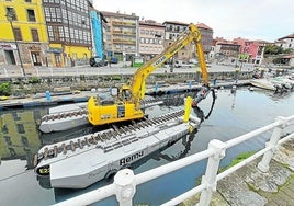 La escavadora anfibia, dotada con una bomba de succión, trabajando en el dragado del puerto de Llanes.