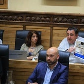 El edil de Tráfico, Pelayo Barcia, muestra durante el Pleno un cartel publicitario del Principado para promocionar la tarjeta Conecta en Gijón.