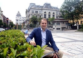 Adrián Pumares, en uno de los bancos del Paseo de los Álamos, con la Junta General al fondo