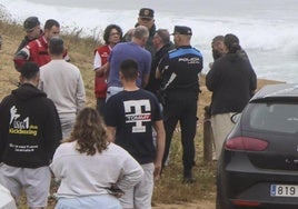 Policía, Guardia Civil y miembros de Cruz Roja, en la playa de Verdicio, atienden a los familiares del pescador fallecido.