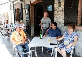 José María Iglesias, Orlando Muñiz y María Ángeles Fernández, sentados en una mesa en Las Caldas, conversando sobre la peligrosidad del río.