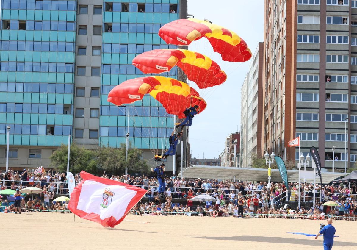 Paracaidistas toman tierra con la bandera de Gijón.