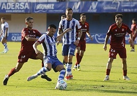 Natalio se dispone a golpear el balón presionado por Bicho en el amistoso frente a la Cultural Leonesa en el Suárez Puerta.
