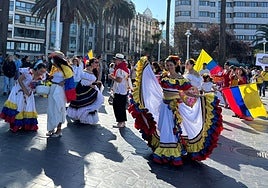 Uno de los grupos que participaron en la marcha, con trajes y banderas de Colombia.