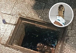 La alcantarilla de la calle Canóniga en Oviedo. En el círculo, la pierna lesionada de la mujer.