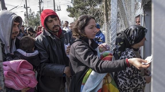 Un grupo de refugiados pasa el control fronterizo para pasar de Grecia a Macedonia. 