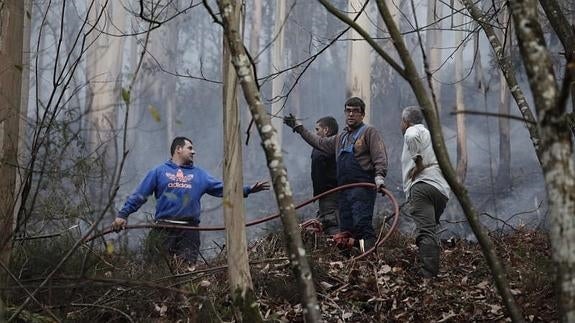 Vecinos del occidente asturiano en una de las zonas afectadas por los incendios de diciembre.