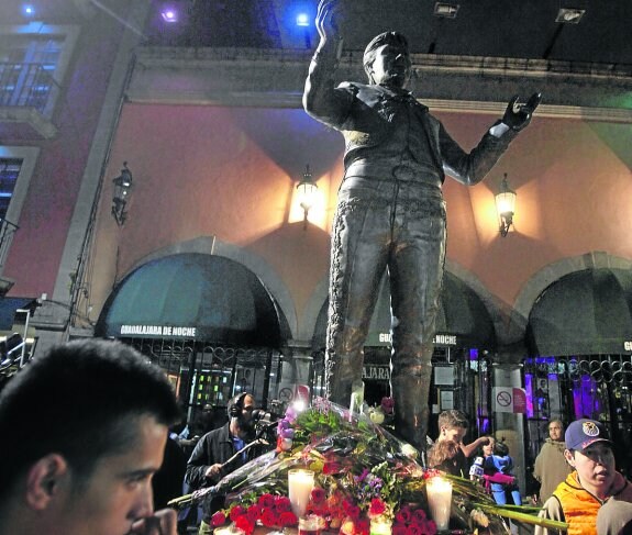 Cientos de personas lloran a Juan Gabriel, en la plaza Garibaldi de Ciudad de México, en el recuadro pequeño, una imagen del cantante fallecido. 