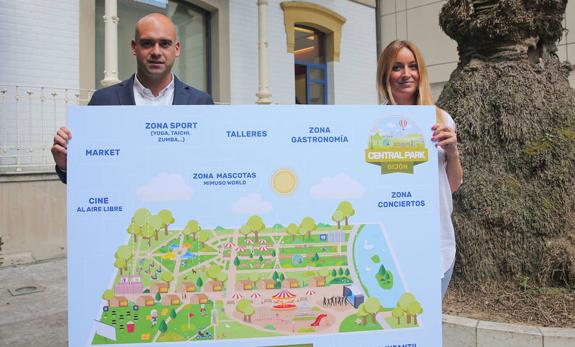 Jesús Martínez y Suca García posan con el mapa del festival en la sede de Divertia. 