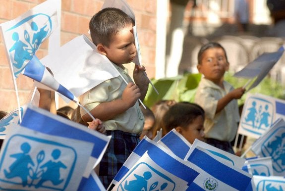 Un grupo de niños que convive en una de las aldeas repartidas por el mundo enarbola sus banderas. 