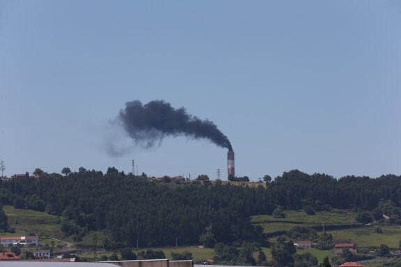 Un denso humno negro sale de la chimenea de Aboño. 