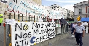 Un hombre observa las pancartas colocadas por los 'indignados' en la Puerta del Sol ::
EFE