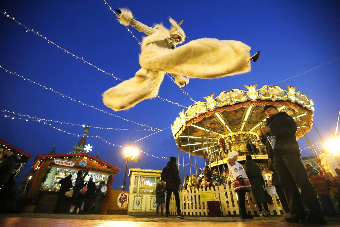 Acrobacias en Moscú. Un artista actúa en el primer día de una feria organizada por los grandes almacenes rusos GUM en la Plaza Roja de Moscú, el 29 de noviembre.