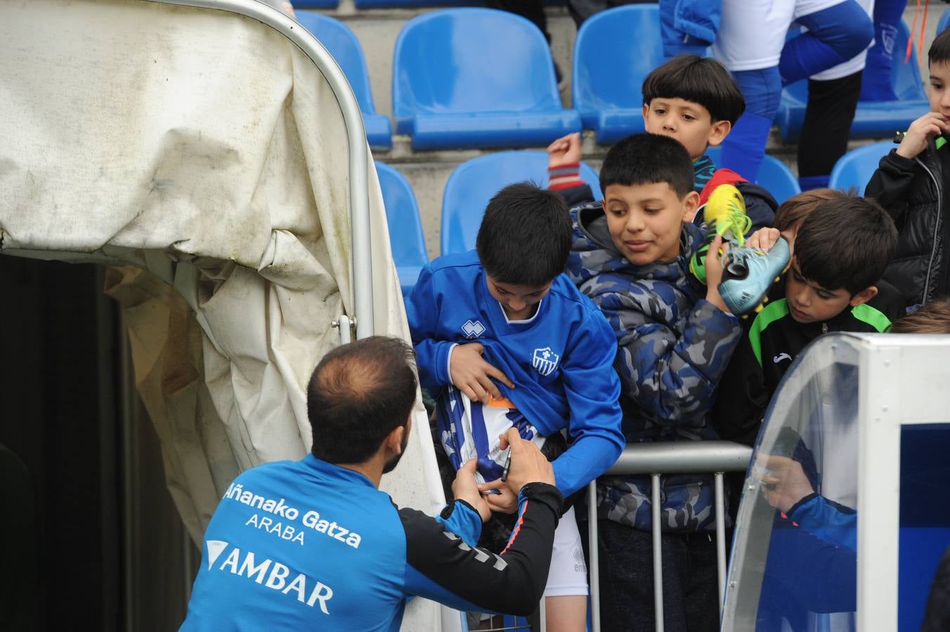 Los jugadores saludan y firman autógrafos a los niños