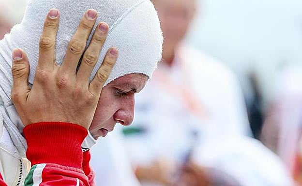 Mick Schumacher se ajusta la protección antes de subirse al coche. 