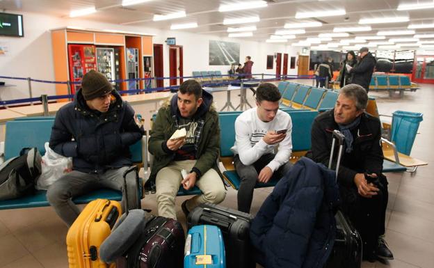 Varios pasajeros aguardan la salida de su vuelo en la sala de espera de Foronda.