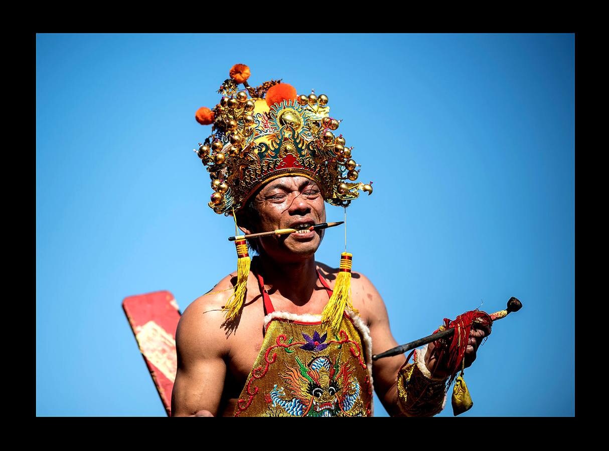 «El tablero de los dioses oceánicos» es uno de los más sorprendentes festivales que se celebran en Fuye, una localidad de la isla de Nanri, en la provincia china de Fujian. Vestidos con prendas bordadas y coronadas sus cabezas con intrincadas coberturas, una veintena de participantes cantan y blanden espadas y estandartes mientras son transportados hacia el mar en palanquines portados por convecinos. La pesca sigue siendo un trabajo arriesgado para los moradores de Fuye, que se hacen a la mar en pequeñas embarcaciones acompañados por imágenes y estatuillas para que los dioses les protejan. «Podemos pedirles que nos mantengan a salvo en el mar, pero no pueden darnos peces ni decirnos dónde hay más,» dijo Zhou, uno de tantos pescadores que estudia inglés con la esperanza de obtener trabajo en un barco de altura.