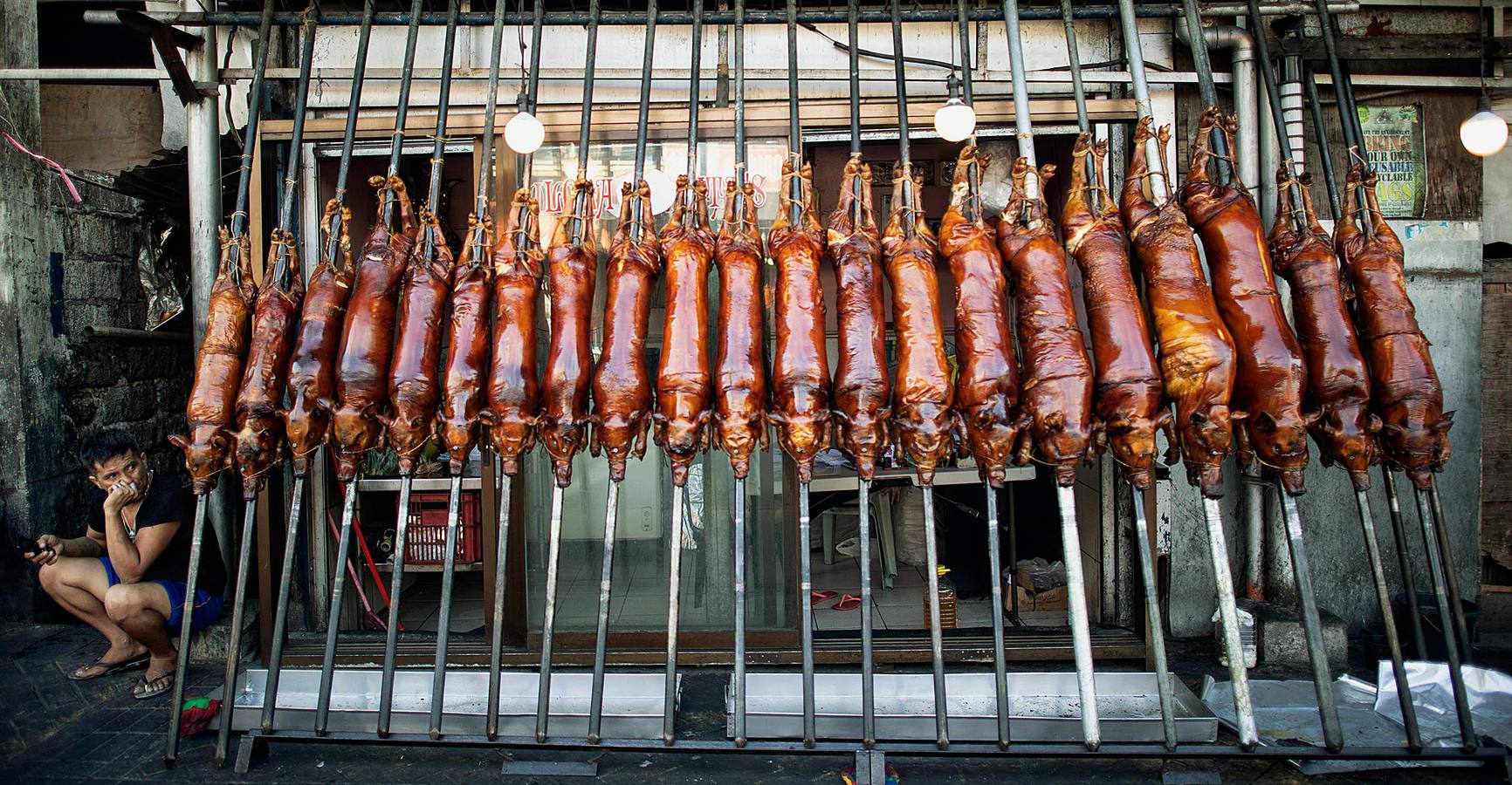 El territorio filipino está compuesto por más de 7.000 islas en las que se distribuyen los 100 millones de habitantes del país. Su complicada interconexión insular ha facilitado la aparición en el tiempo de una enorme variedad de lenguas y comidas locales. Una de ellas es el lechón relleno con papaya y hojas de tamarindo, que se pone a la brasa y se sirve con arroz acompañado con salsa de hígado. Los lechoneros (los vemos en las fotos) se dedican a girar el asado durante horas y lo bañan de tanto en tanto con agua de coco.