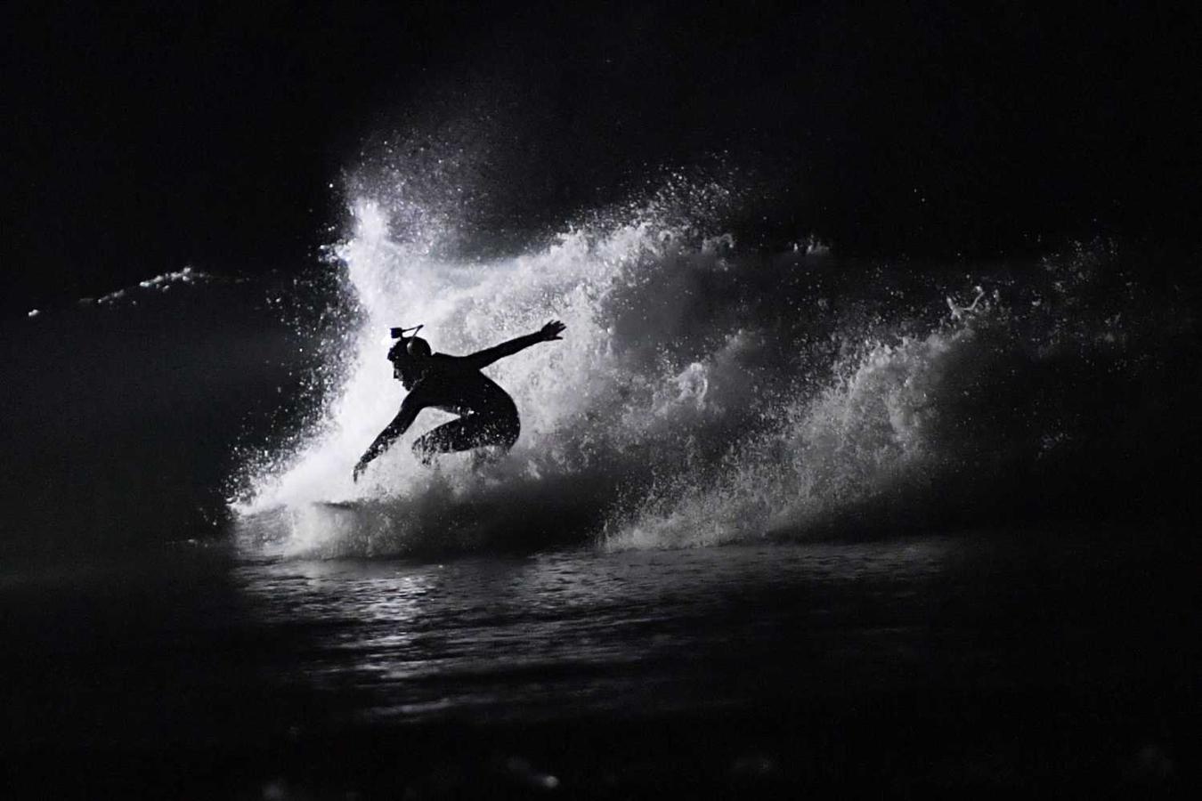 Los surfistas Yann Le Her, Alan, Yohann, Robin y Damien desafían el frío y la oscuridad en una sesión de surf nocturno en la playa del Cabo Fréhel, Bretaña