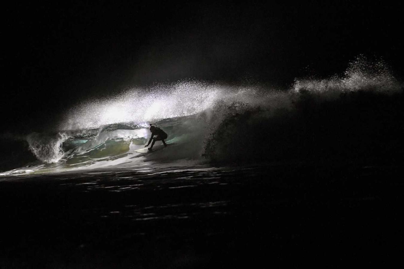 Los surfistas Yann Le Her, Alan, Yohann, Robin y Damien desafían el frío y la oscuridad en una sesión de surf nocturno en la playa del Cabo Fréhel, Bretaña