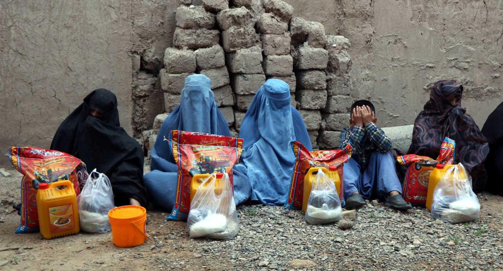 Afganos reciben comida de la ONG "Ehsas" durante el Ramadán, en Herat 