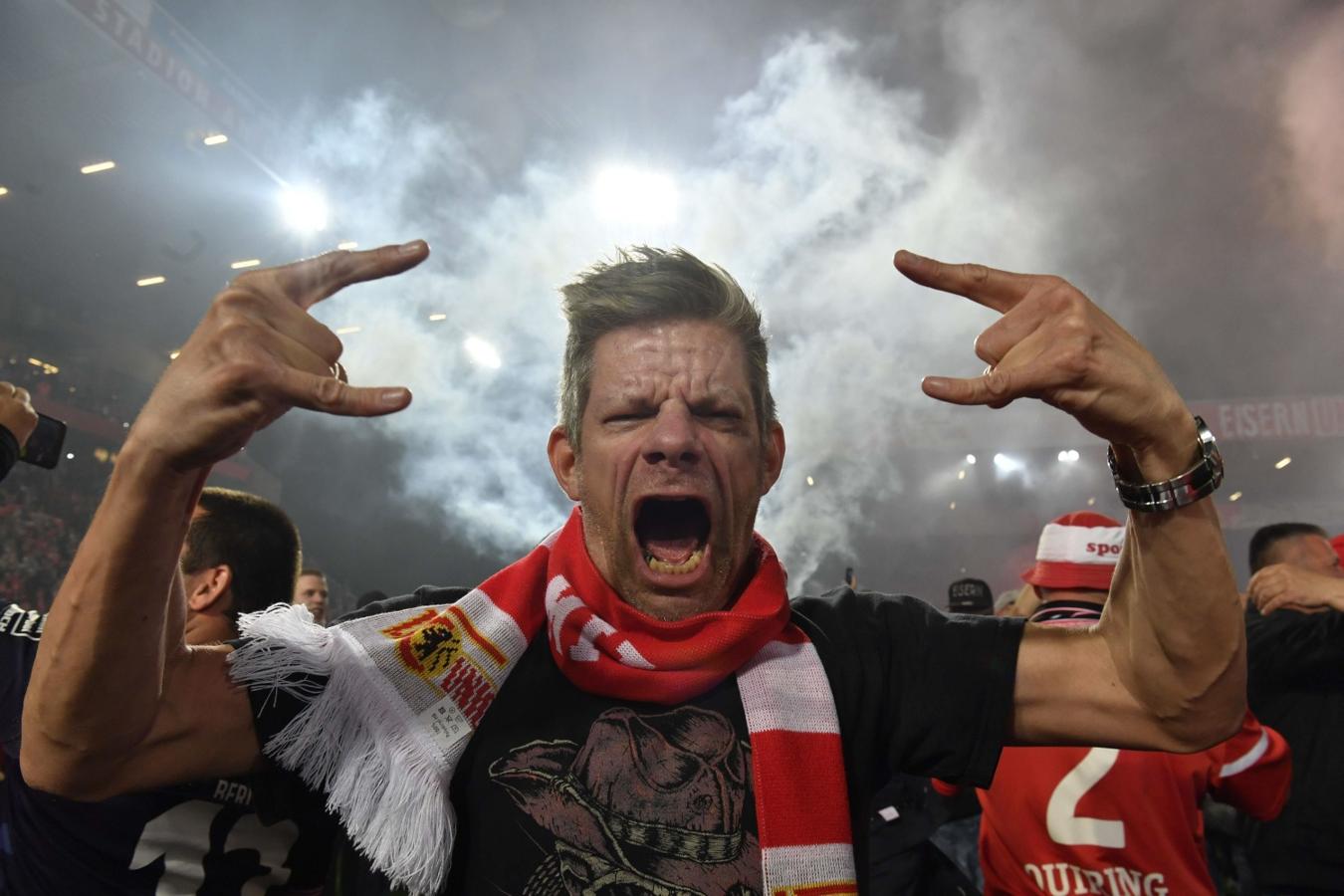 Un aficionado del Union Berlin celebra en el campo tras la victoria en el partido de fútbol ante el VfB Stuttgart, en Berlín, consiguiendo el ascenso a primera división. 