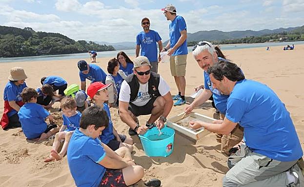 Voluntarios limpian la playa.