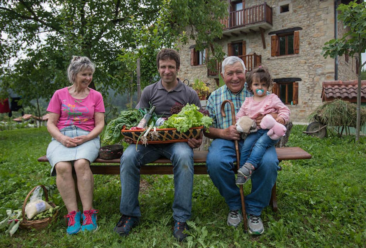 Unai Bilbao, del caserío Etxerriaga, posa junto a sus padres y su hija.