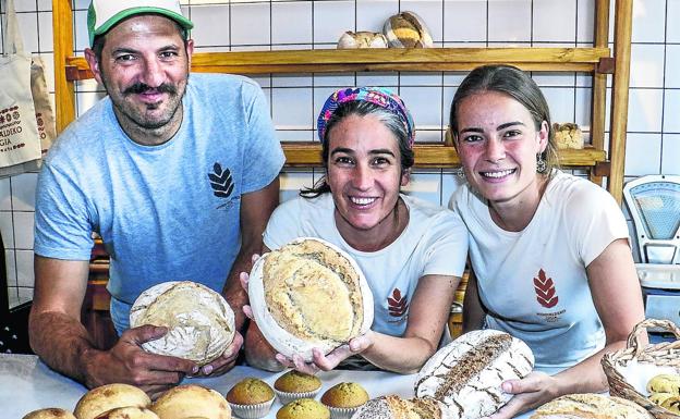 Mendialdeko Ogia, en Maeztu. Natxo Beltrán de Heredia, su pareja Ana Montserrat y Cindy Toivainen posan con la amplia variedad de panes y bollería que ofrecen en su panadería ecológica de Maeztu, pueblo al que se trasladaron hace tres meses desde Azáceta.