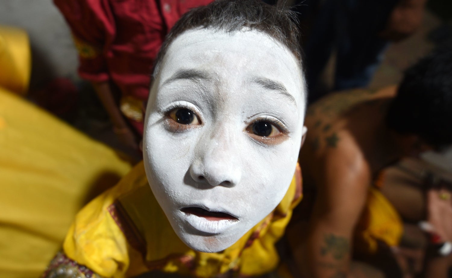 Un joven artista nepalí con la cara pintada mira antes de actuar en una obra basada en la mitología hindú en la plaza Basantapur Durbar en el penúltimo día del festival hindú 'Indra Jatra' en Katmandú 