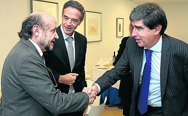 El economista Alfredo Arahuete, junto a Guillermo Dorronsoro, director zona norte en Ibermática, saluda a Manuel Martín Muñio, director general de Norbolsa, tras su conferencia en BBK Behatokia+. 
