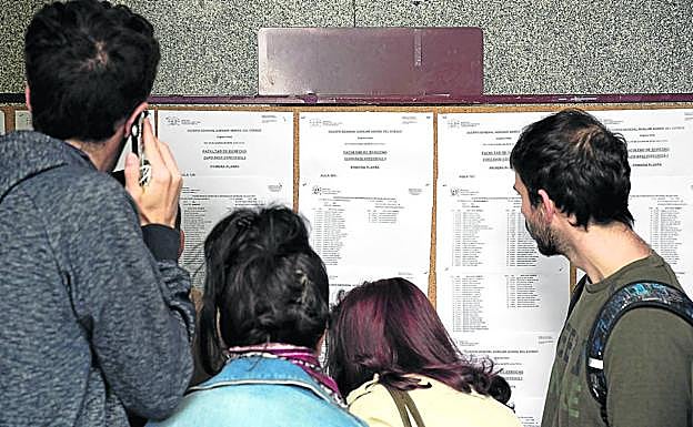 Opositores se buscan en unas listas, el pasado 19 de octubre, cuando se celebró el primer proceso de selección para cubrir 8.102 plazas en la Administración general. 