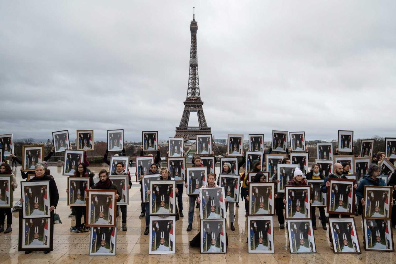 Activistas franceses de la asociación de Acción No Violenta COP21 en la explanada de Trocadero frente a la Torre Eiffel para denunciar la inacción del gobierno contra el calentamiento global
