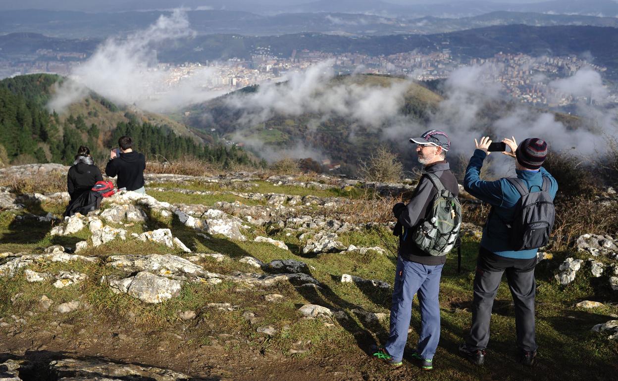 Montañeros disfrutan de las vistas desde la cima del Pagasarri.