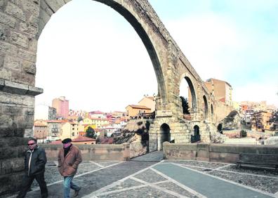 Imagen secundaria 1 - 1. Estudiantes del instituto Vega del Turia hacen la 'v' de victoria en la estación de Renfe. | 2. Un par de transeúntes pasean bajo el viaducto de Fernando Hué, que une el casco histórico con el Ensanche. | 3. Juan Carlos, un ingeniero agrónomo, y Lourdes, médica, ambos de Almería, consultan el mapa turístico de Teruel desde la torres mudéjar de El Salvador. 