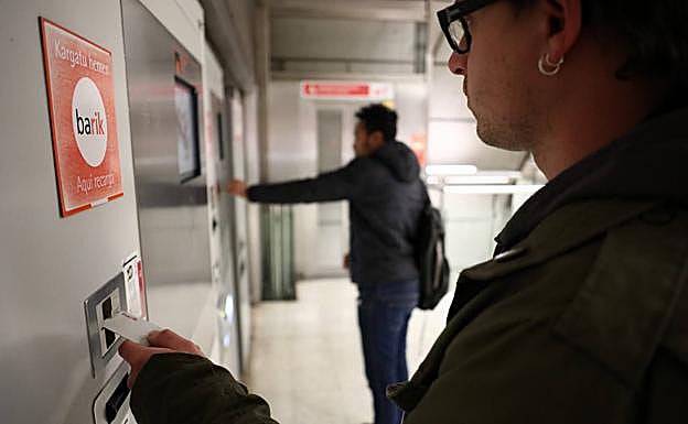 Un joven introduce su barik en las máquinas de recarga del metro.