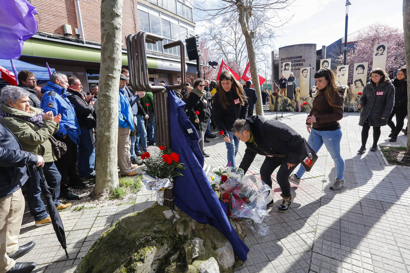 Representantes de LAB depositan claveles frente al monolito. 