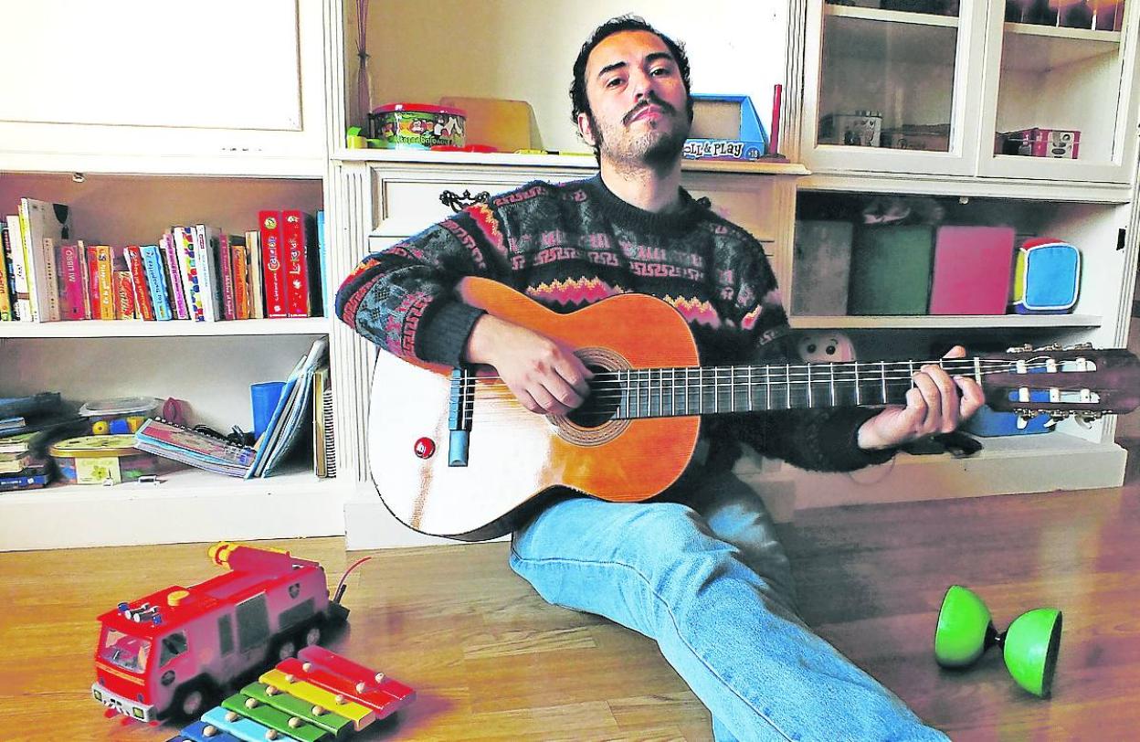 El cantautor Cristian Vergara tocando la guitarra en el salón de su casa, en Bilbao.