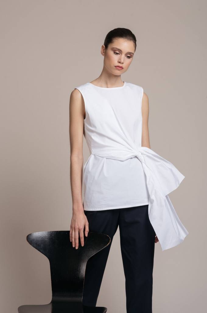 Top de popelín blanco elástico sin mangas de la firma vasca Minimil. Tiene grandes tiras para anudar en la cintura. Costaba 112 euros y ahora lo puedes encontrar por 67,20 euros en su tienda bilbaína, situada en Alameda Recalde.