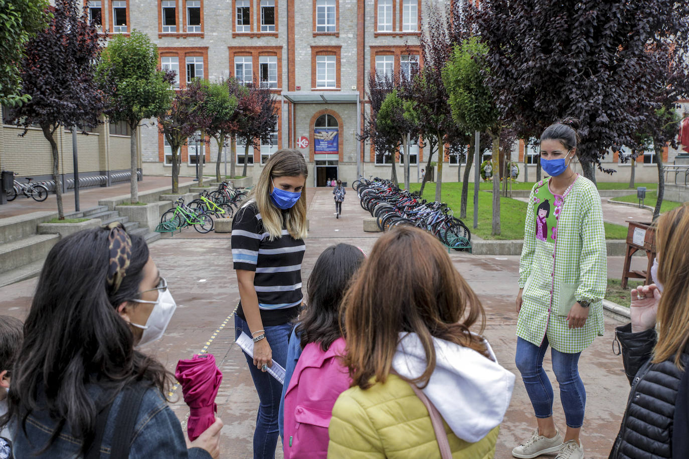 Dos profesoras reciben a los primeros alumnos que han llegado este lunes al colegio Corazonistas de Vitoria.