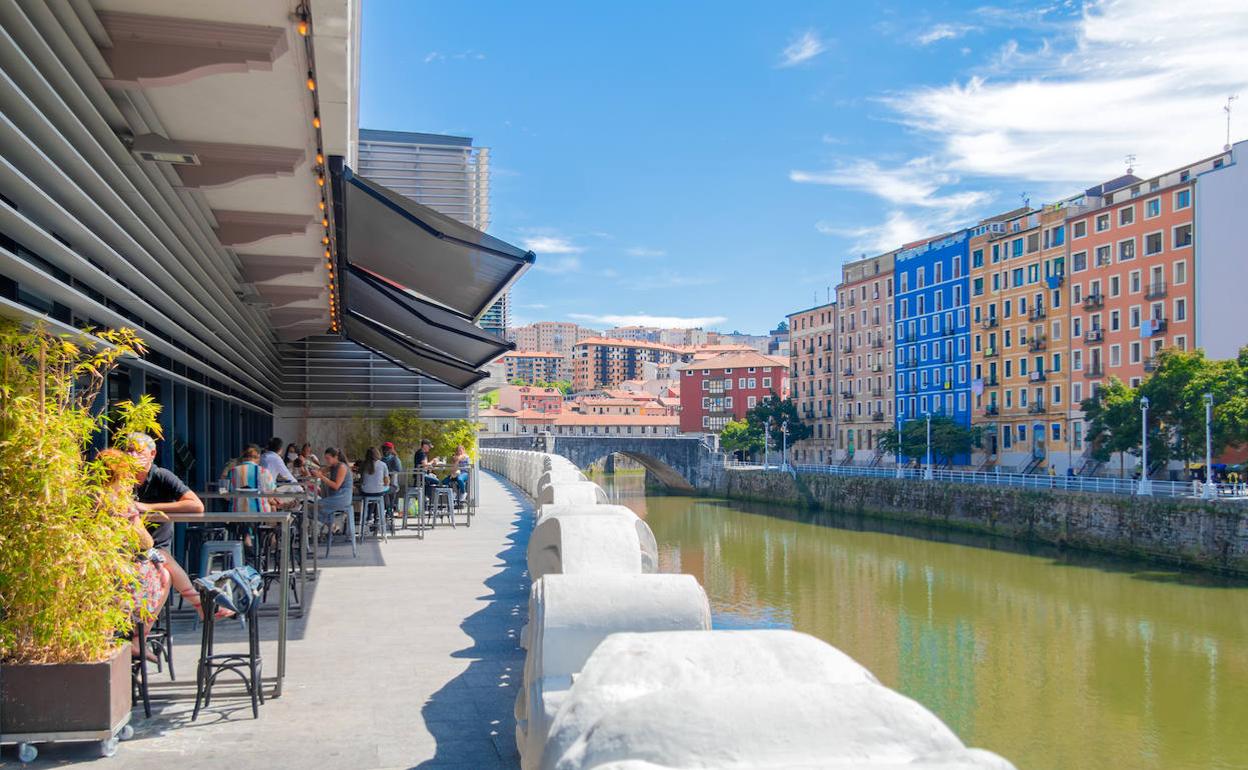 Las vistas a la ría y a los coloridos edificios del muelle Marzana enriquecen la estancia en las terrazas de La Ribera.