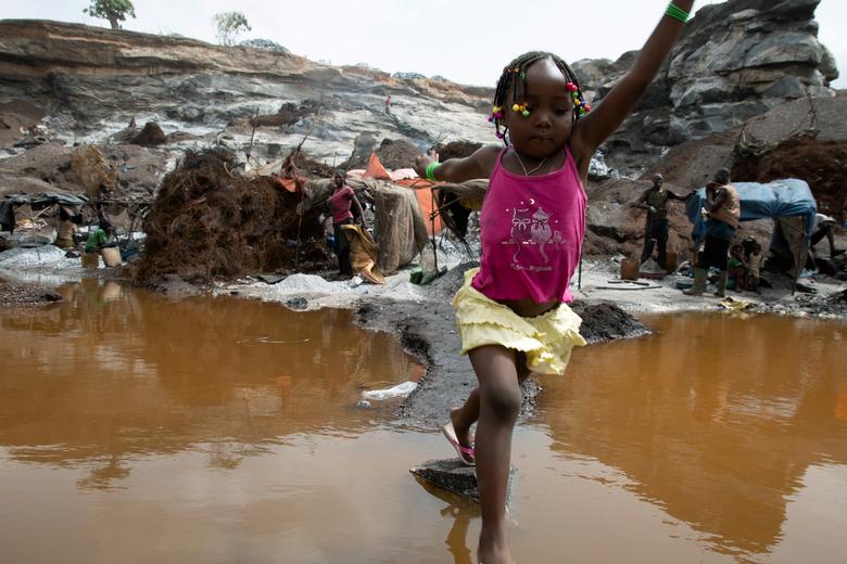 Burkina Faso. Melissa Kabore, de 4 años, salta sobre un charco en la cantera informal de granito Pissy desde que las escuelas cerraron en medio del brote de coronavirus en Ouagadougou, Burkina Faso.