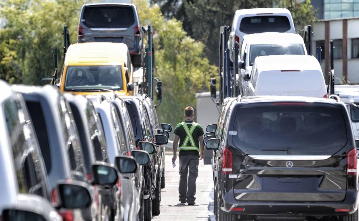 Un operario camina por el parking de Mercedes entre furgonetas ya acabadas y listas para su venta.