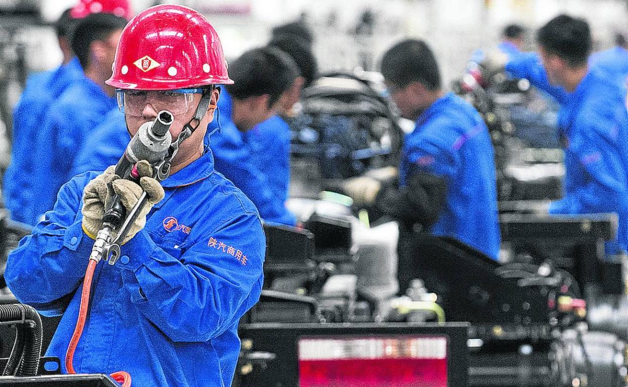 Trabajadores en una cadena de montaje de camiones en Guiyang. 