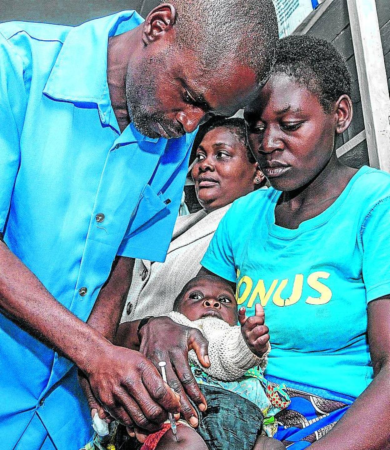 Un médico inyecta una vacuna a un bebé en Malaui. 